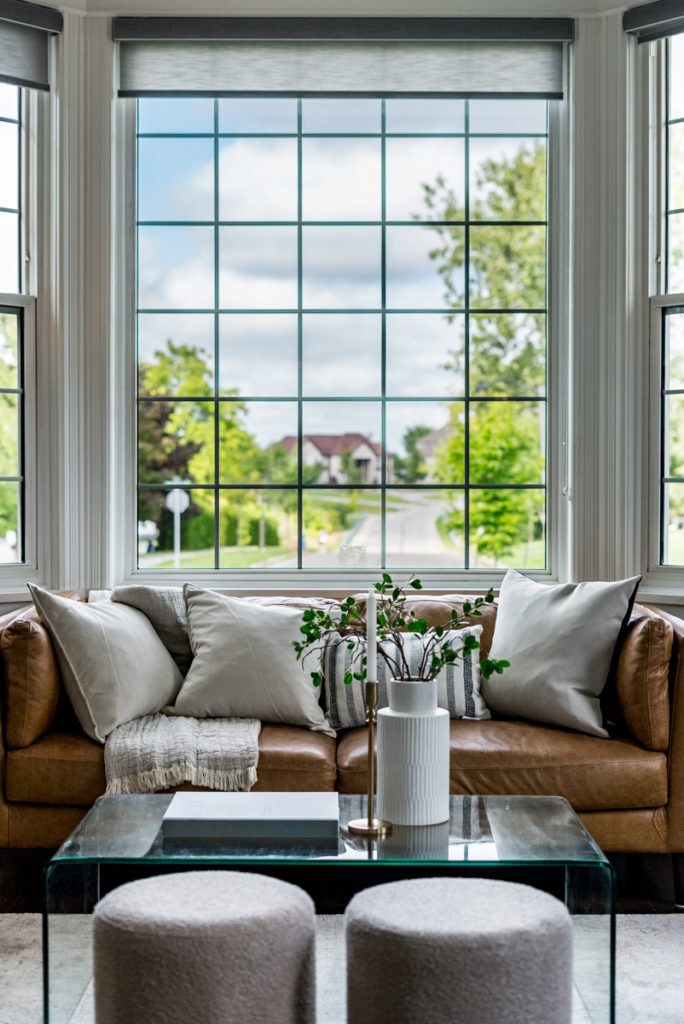 A vertical detail photo of an interior living room showcasing a couch and dining table