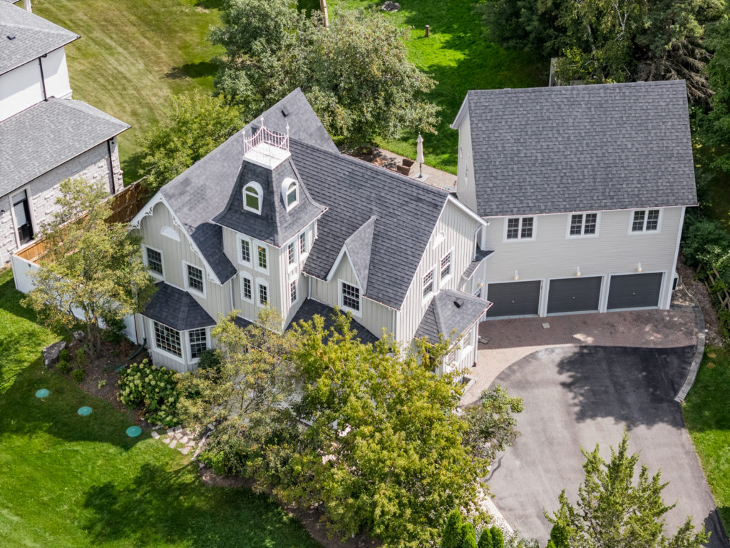 An aerial view of a luxury property with trees and greenery surrounding